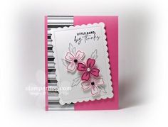 a pink and white card with flowers on it