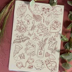 a sheet of stickers with various tattoos on it next to some plants and flowers