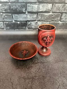 two red bowls sitting next to each other on a table