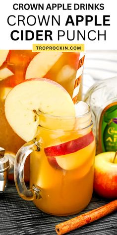 an apple cider punch in a mason jar with apples and cinnamon sticks next to it