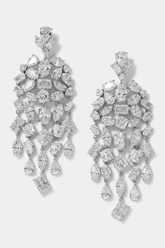 pair of diamond earrings on white background