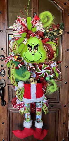 the grinch door hanger is decorated with candy