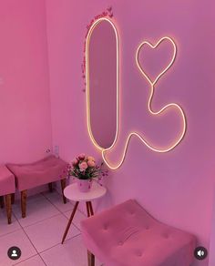 a pink room with two chairs and a mirror on the wall that says i love you