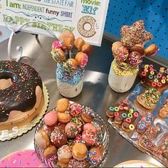 there are many doughnuts on the table with sprinkles around them