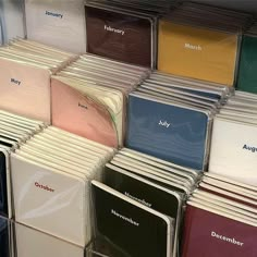 many different colored folders stacked on top of each other