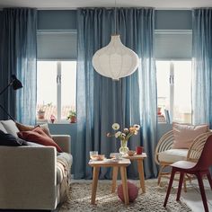 a living room filled with furniture and curtains