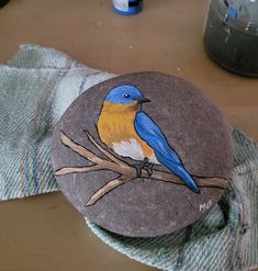 a painted rock sitting on top of a wooden table