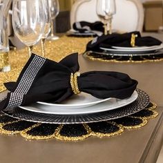 black and gold table setting with place settings