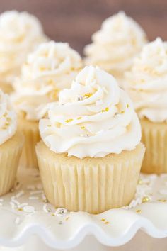 cupcakes with white frosting and gold sprinkles