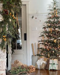 a decorated christmas tree sitting next to a fireplace