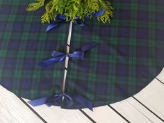 a green and blue plaid table cloth with a tree on it, tied in ribbon