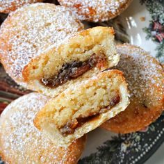 powdered sugar filled pastries on a plate