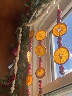 an orange slice hanging from a window sill next to a christmas tree with decorations