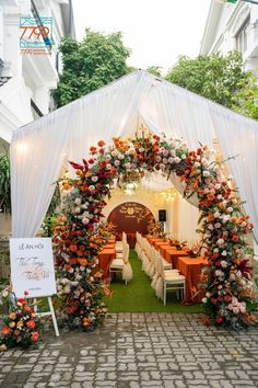 an outdoor wedding venue decorated with flowers and greenery