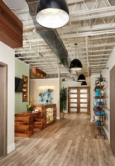 the inside of an office building with wood floors