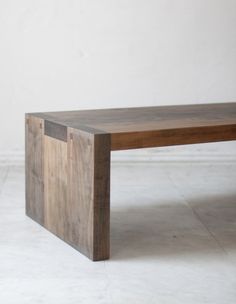 a wooden table sitting on top of a white floor