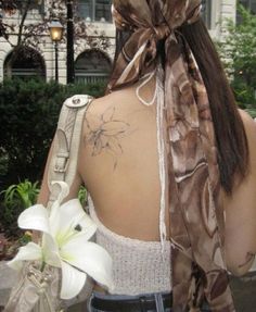 the back of a woman's neck with a flower on it