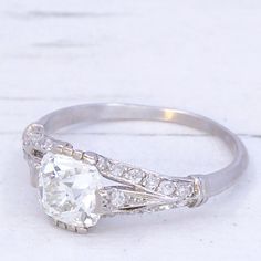 a white gold ring with an old cut diamond