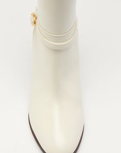 Valentino Garavani Pattie boot in calfskin leather - VLogo Signature accessory with antique-effect brass finish - Calfskin strap with buckle - Leather block heel - Heel height: 75 mm / 3 in. - Boot shaft height: 39 cm / 15.4 in.; Italian size 37 - Made in Italy Elegant Beige Ankle Boots, Elegant Gold Leather Boots, Gold Luxury Calf Leather Boots, Luxury Gold Calf Leather Boots, Formal Gold Calf Leather Boots, Cream Leather Boots With Sculpted Heel, Cream Leather Heeled Boots With Sculpted Heel, Cream Calf Leather Boots With Reinforced Heel, Elegant Almond Toe Boots With Buckle Closure