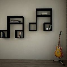 there is a guitar and some shelves on the wall