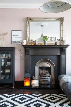 a living room with a fire place and a mirror