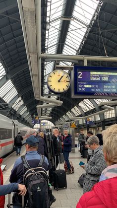 many people are waiting for the train at the station