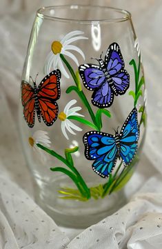 a glass with butterflies painted on it