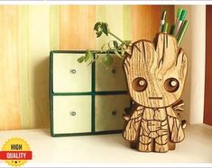 a wooden pencil holder with an image of baby groote