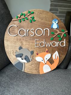 a wooden sign that says,'mason edward'with two foxes and an owl