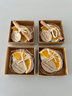 four orange slices wrapped in brown paper and tied with twine on top of each other