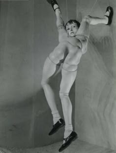 an old black and white photo of a man doing acrobatic tricks