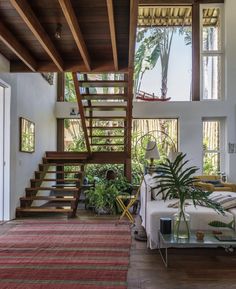 a living room filled with furniture and a stair case