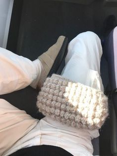 a person laying down in the back seat of a car with their feet propped up