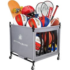 a basket filled with assorted sports balls and tennis racquets on wheels