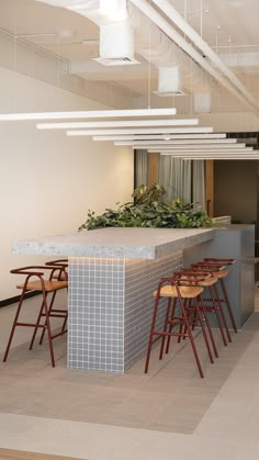 an empty room with stools and barstools in front of a bar counter