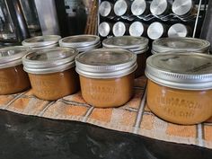 several jars of peanut butter sitting on a table