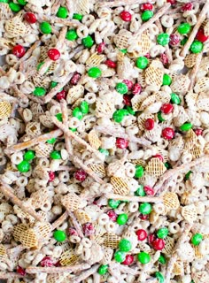 a mixture of cereal, candy and pretzels in a bowl