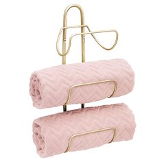 two pink towels are hanging on a metal rack and one has a gold holder for it