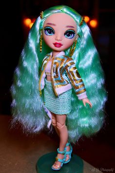 a doll with green hair and blue eyes