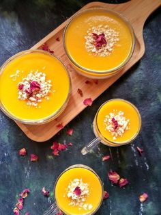 three glasses filled with orange juice and garnished with flowers