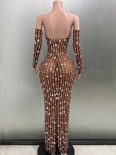 a mannequin wearing a brown and white dress with sequins on it