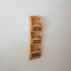 a wooden wall mounted shelf with three shelves on each side and the words mr and mrs spelled in black