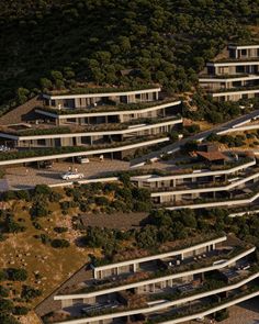 an aerial view of a building surrounded by trees and bushes, with multiple levels on each level