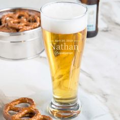 a beer and pretzels sitting on a table