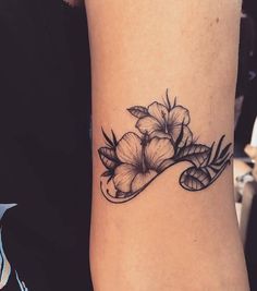 a woman's arm with flowers on it