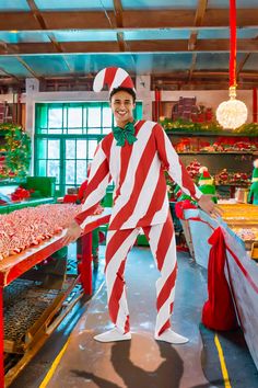 a man dressed in a candy cane costume