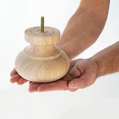 a person holding a wooden object in their hand