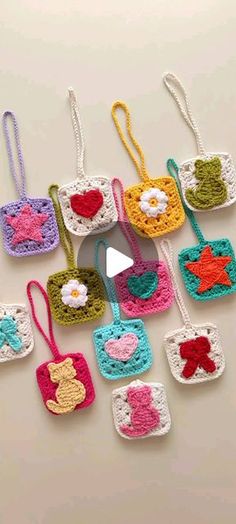 crocheted purses with hearts and stars hanging from the handles on a table