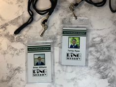 two lanyard id badges on a marble counter