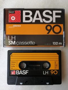 an old cassette with the word basf 90 on it next to another tape recorder